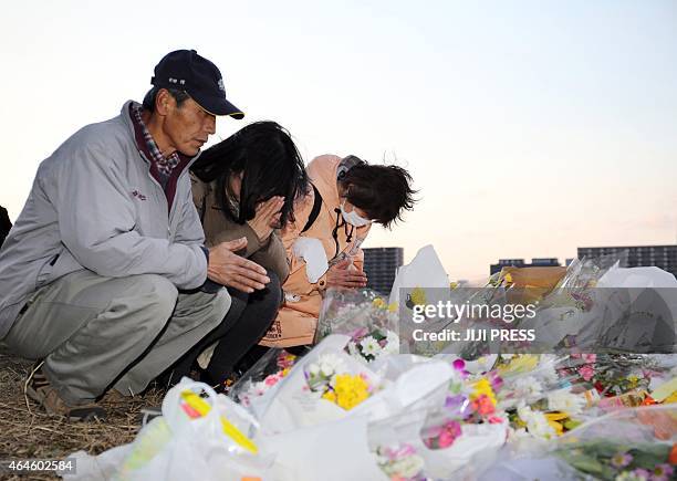 People pray for Ryota Uemura at a riverside area in Kawasaki, suburban Tokyo on February 27, 2015. Japanese police on February 27 arrested three...