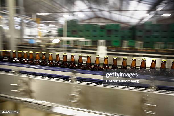 Bottles of Meta beer pass along the production line at the Meta Abo brewery, operated by Diageo Plc in Sebeta, Ethiopia, on Wednesday, Feb. 25, 2015....