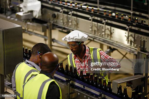 Worker looks on as bottles of beer pass along the production line at the Meta Abo brewery, operated by Diageo Plc in Sebeta, Ethiopia, on Wednesday,...