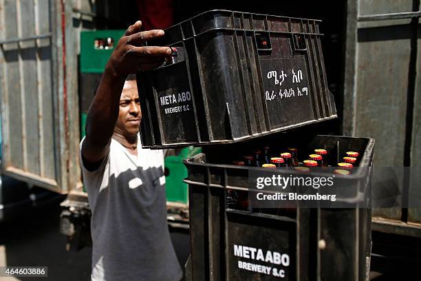 Workers collect used beer bottles and deliver crates of beer produced at the Meta Abo brewery, operated by Diageo Plc, in Sebeta, Ethiopia, on...