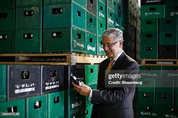 Ivan Menezes, chief executive officer of Diageo Plc, poses for a photograph with a bottle of beer during a visit to the Meta Abo brewery, operated by...