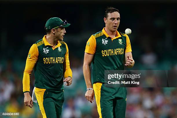 Kyle Abbott of South Africa speaks to Faf du Plessis before bowling during the 2015 ICC Cricket World Cup match between South Africa and the West...