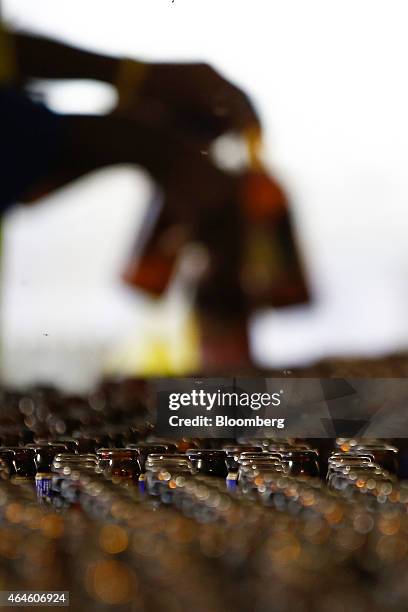 Worker recycles used bottles of Guinness Malt and Meta beer, at the Meta Abo brewery, operated by Diageo Plc in Sebeta, Ethiopia, on Wednesday, Feb....