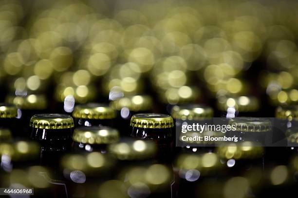 Bottles of Meta beer pass along the production line at the Meta Abo brewery, operated by Diageo Plc in Sebeta, Ethiopia, on Wednesday, Feb. 25, 2015....
