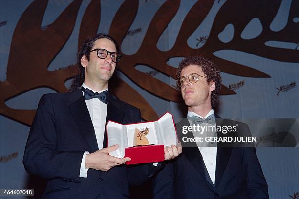 Film directors Ethan and Joel Coen pose with the Palme d'Or for their film "Barton Fink" during the closing ceremony at the 44th edition of the...