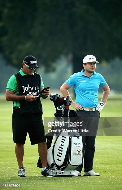 Tyrrell Hatton of England stands with his caddie, Kyle Roadley during the second round of the Joburg Open at Royal Johannesburg and Kensington Golf...