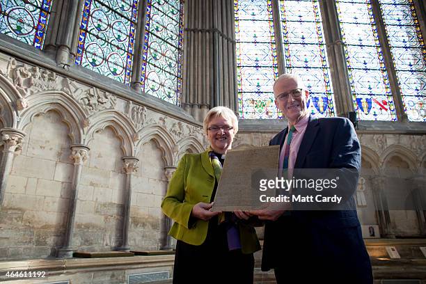 The Very Revd. June Osborne, Dean of Salisbury and Simon Timms, Chair of the Heritage Lottery Fund South West Committee, hold a modern day copy of...