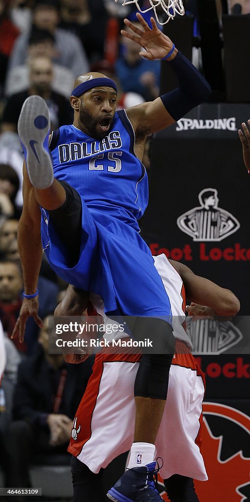 Dallas Raptors TORONTO - JANUARY 22 - Mavs Vince Carter ends up on the back of DeMar ...