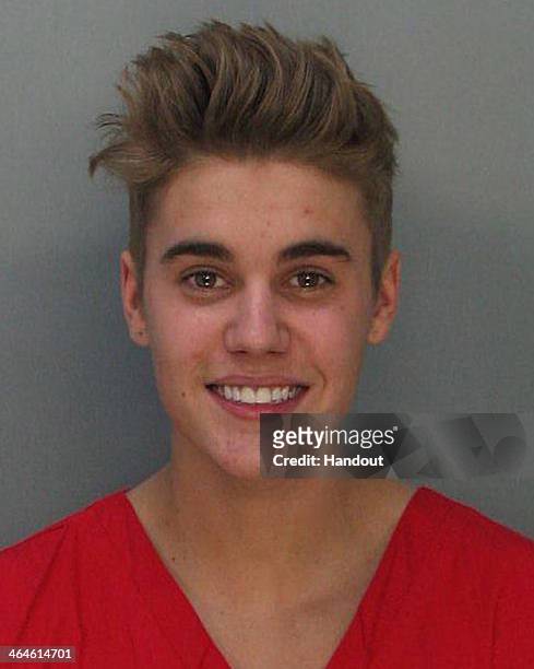 In this handout photo provided by Miami-Dade Police Department, pop star Justin Bieber poses for a booking photo at the Miami-Dade Police Department...