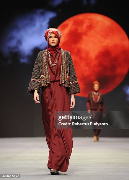 Model showcases designs by Nieta Hidayani on the runway in the Caravansary show during Indonesia Fashion Week 2015 at Jakarta Convention Center on...