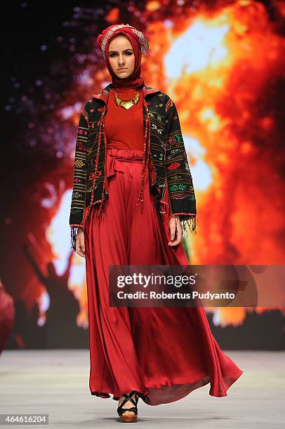 Model showcases designs by Nieta Hidayani on the runway in the Lune de Feu show during Indonesia Fashion Week 2015 at Jakarta Convention Center on...