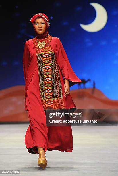 Model showcases designs by Nieta Hidayani on the runway in the Lune de Feu show during Indonesia Fashion Week 2015 at Jakarta Convention Center on...