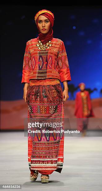 Model showcases designs by Nieta Hidayani on the runway in the Caravansary show during Indonesia Fashion Week 2015 at Jakarta Convention Center on...