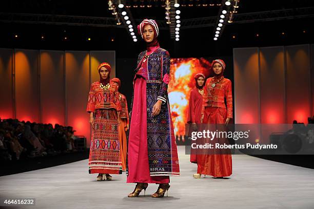 Models showcase designs by Nieta Hidayani on the runway in the Lune de Feu show during Indonesia Fashion Week 2015 at Jakarta Convention Center on...