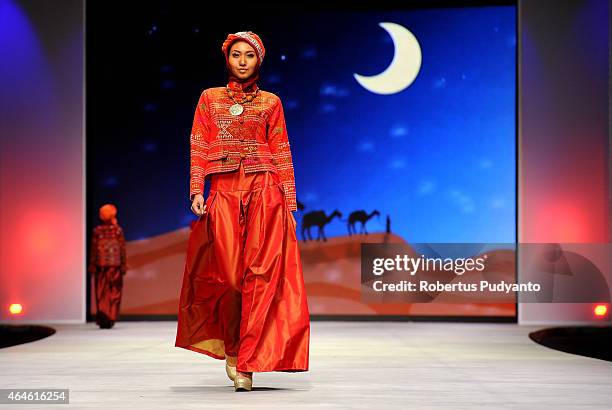 Model showcases designs by Nieta Hidayani on the runway in the Lune de Feu show during Indonesia Fashion Week 2015 at Jakarta Convention Center on...