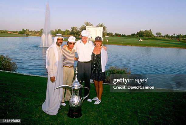 Ernie Els of South Africa with his manager Sam Feldman and his girlfriend Liezl the trophy after the final round of the 1994 Dubai Desert Classic on...