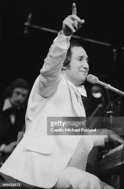 American singer-songwriter and pianist Neil Sedaka performing with an orchestra, February 1974.