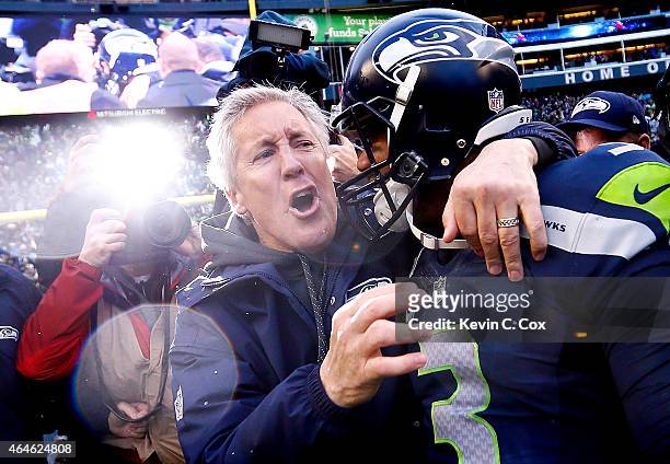 Head coach Pete Carroll and Russell Wilson of the Seattle Seahawks celebrate after the Seahawks 28-22 victory in overtime against the Green Bay...