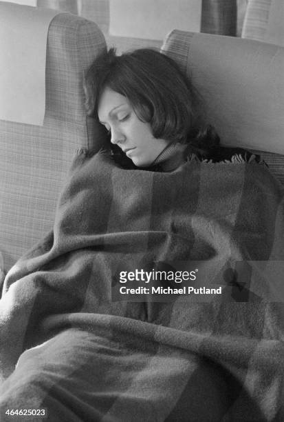 American singer and drummer Karen Carpenter , of pop duo The Carpenters, sleeping on an aircraft during a European tour, Frankfurt, West Germany,...