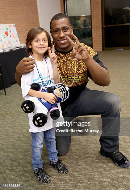 Patient Jordan Montes and USC footall player Marcus Martin attend the Starkey Hearing Foundation Mission during GRAMMY Camp at University of Southern...