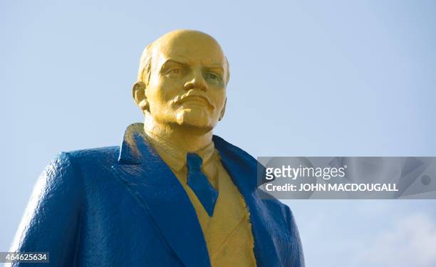 Picture taken on February 27, 2015 shows a statue of late Soviet leader Vladimir Lenin painted with the colours of the Ukrainian flag in the...