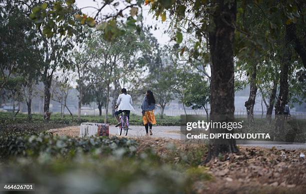 Indian tribal residents travel along a road at the Dagapur tea garden on the outskirts of Siliguri in the eastern state of West Bengal on January 23,...