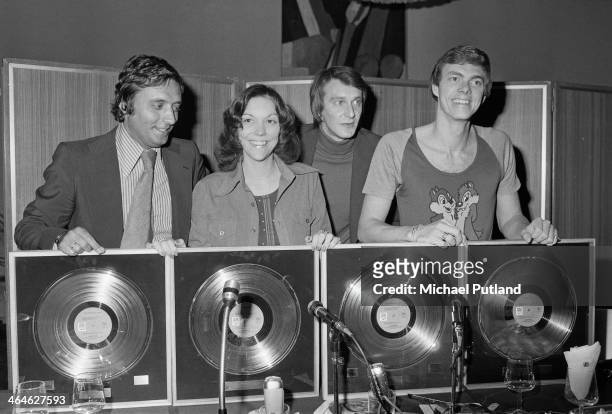 American pop duo The Carpenters, Karen Carpenter and her brother Richard , with awards for sales of their album 'Now & Then' and their compilation...