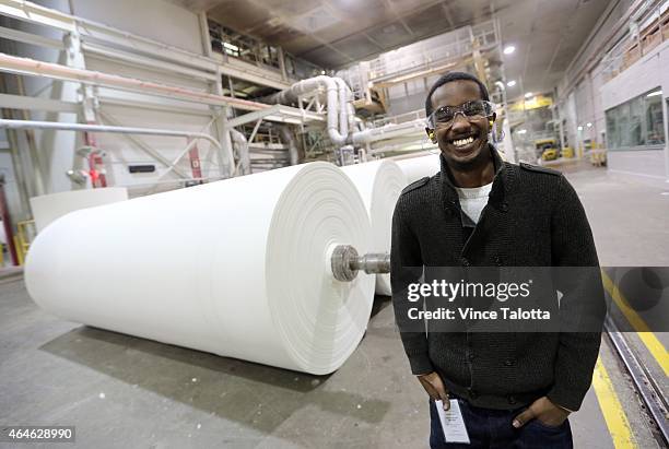 Abrone Hassan stands in front of a paper mill that produces paper towel, facial and bathroom tissue on the factory floor of Irving Tissue, where he...