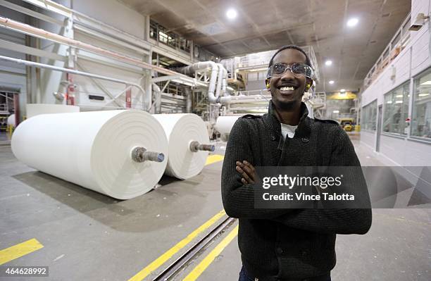 Abrone Hassan stands in front of a paper mill that produces paper towel, facial and bathroom tissue on the factory floor of Irving Tissue, where he...