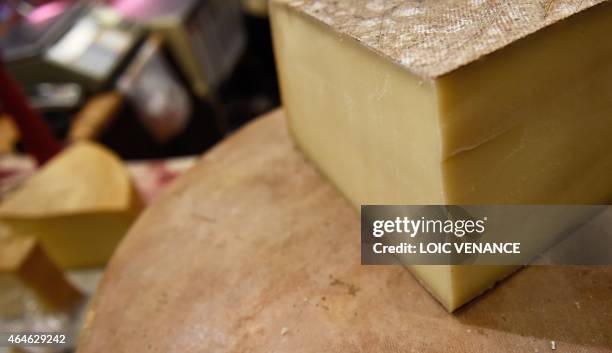 Picture taken on February 26, 2015 shows Comte cheeses during the Paris international agricultural fair at the Porte de Versailles exhibition center...