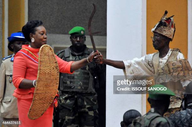 Catherine Samba Panza , the new Central African Republic president, receives a shield and a sword from a tribal chief during her swearing-in ceremony...