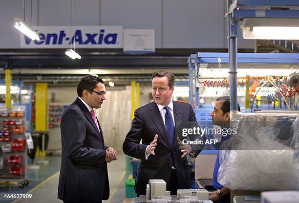 British Prime Minister David Cameron tours the Vent-Axia factory with Chief Executive Ronnie George in Crawley, West Sussex, southern England on...