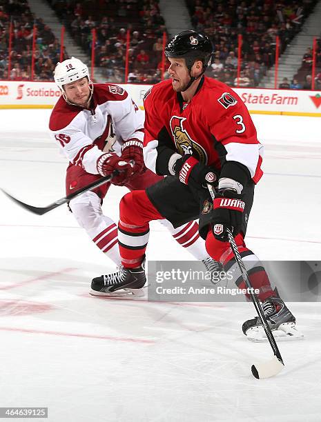 Marc Methot of the Ottawa Senators skates against David Moss of the Phoenix Coyotes at Canadian Tire Centre on December 21, 2013 in Ottawa, Ontario,...