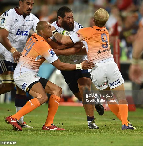 Charlie Faumuina of the Blues and Cornal Hendricks with Sarel Pretorius of the Cheetahs during the Super Rugby match between Toyota Cheetahs and...