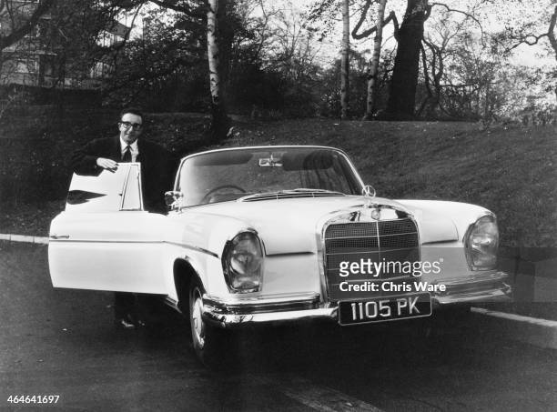 English comic actor Peter Sellers with his new Mercedes-Benz 300 SE Cabriolet , 7th November 1962. Sellers bought the car for eight thousand pounds,...