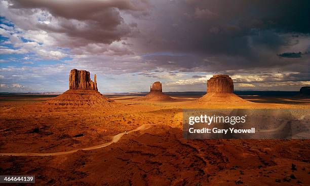 mittens at sunset with storm clouds overhead - overhead desert stockfoto's en -beelden