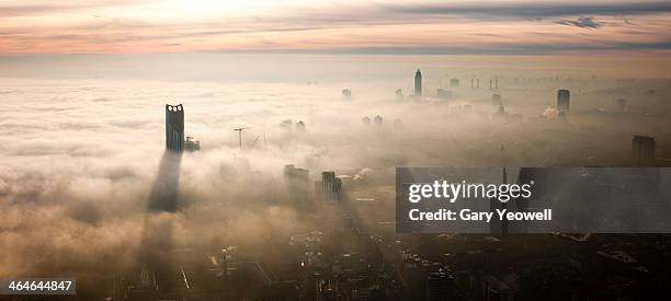 elevated view over london shrouded in mist - fog london stock pictures, royalty-free photos & images