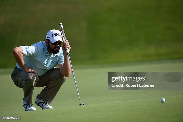 Edward Loar assesses a putt on the 11th green during the first round of the Farmers Insurance Open on Torrey Pines South on January 23, 2014 in La...