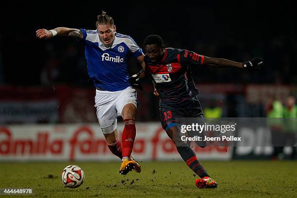 Manuel Schaeffler of Kiel and Steve Gohouri of Erfurt compete the ball during the Third League match between Holstein Kiel and RW Erfurt at...