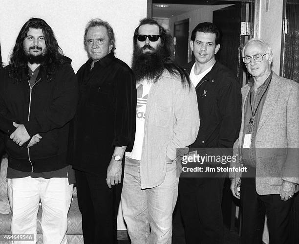 Johnny Cash poses with Rick Rubin, Lou Robin and others backstage at the Greek Theatre in Los Angeles, California on June 14, 1997.