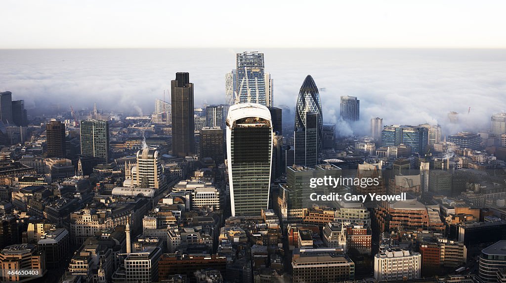 Elevated view over City of London shrouded in mist