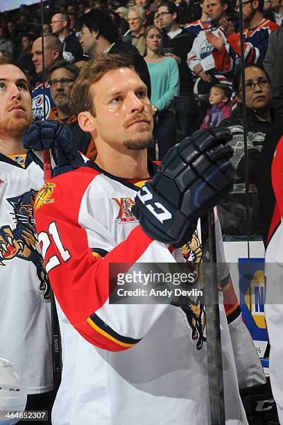 Krys Barch of the Florida Panthers stands for the singing of the national anthem prior to a game against the Edmonton Oilers on November 21, 2013 at...