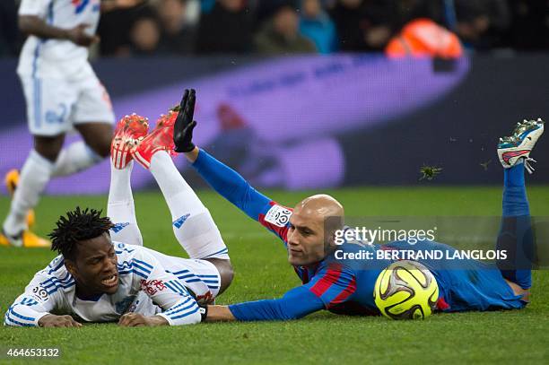 Marseille's Belgian forward Michy Batshuayi vies with Caen's French defender Alaeddine Yahia during the French L1 football match between Marseille...