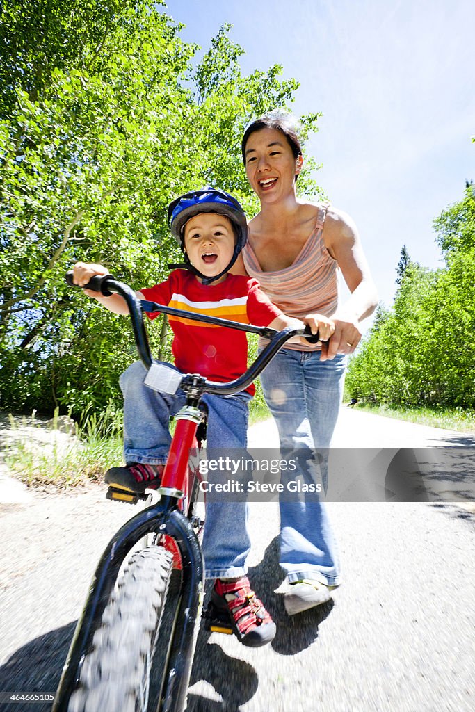 Boy learns to ride his peddle bike