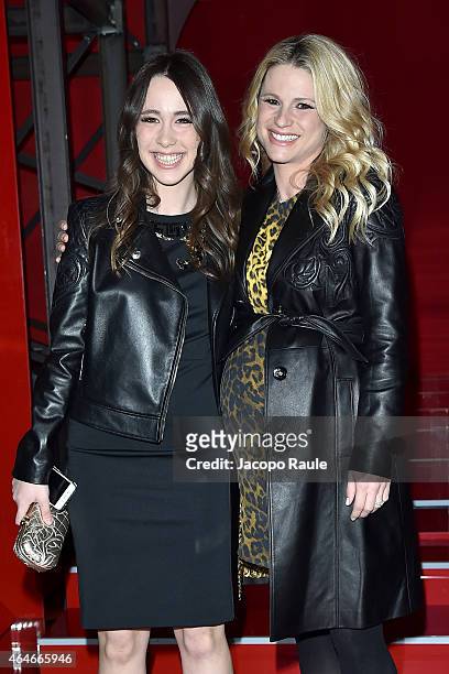 Aurora Ramazzotti and Michelle Hunziker attend the Versace show during the Milan Fashion Week Autumn/Winter 2015 on February 27, 2015 in Milan, Italy.