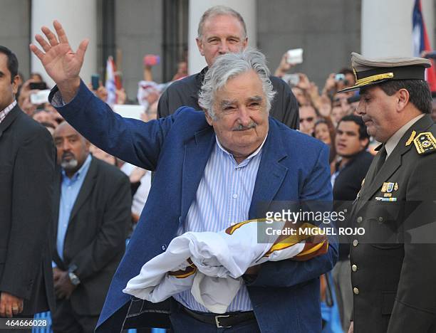 Uruguayan President Jose Mujica waves during a farewell ceremony in Montevideo on February 27 two days before the swearing in ceremony of the...