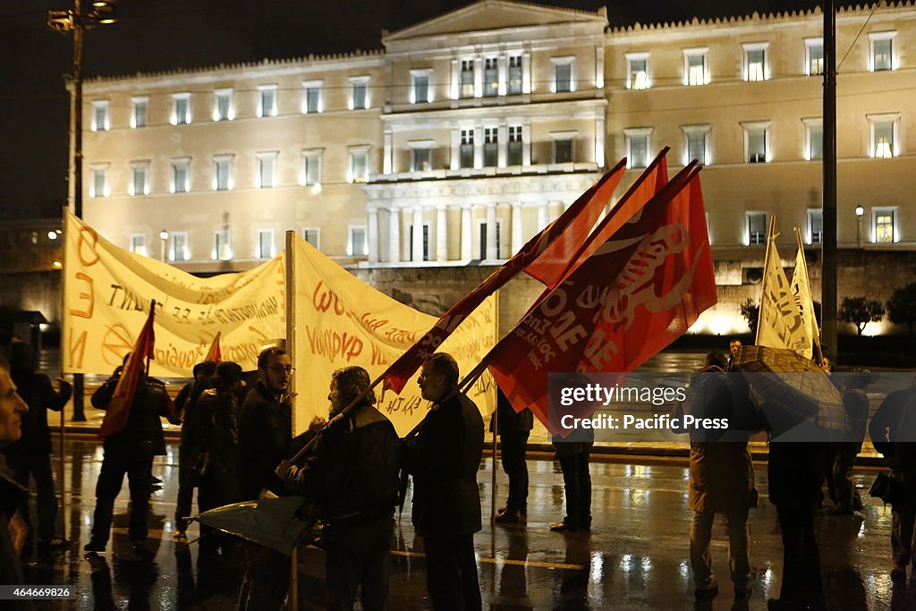 The protesters stand outside the Greek Parliament. Greeks...