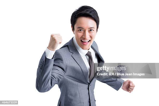 excited businessman punching the air - yes stockfoto's en -beelden