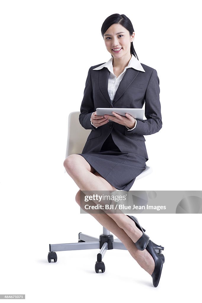 Happy businesswoman with digital tablet