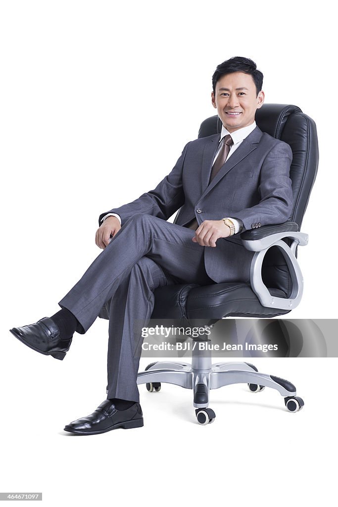 Mature manager sitting in chair